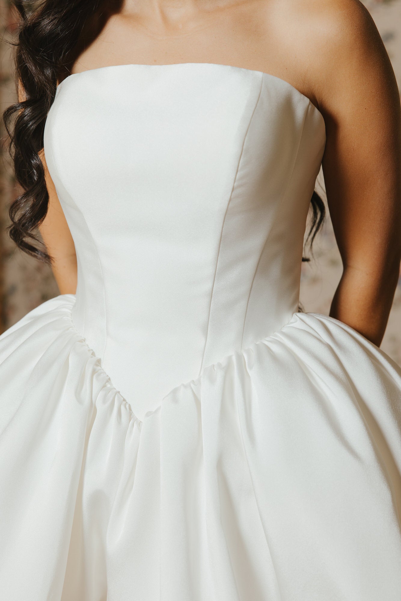 White strapless gown with a soft texture, worn by a person.