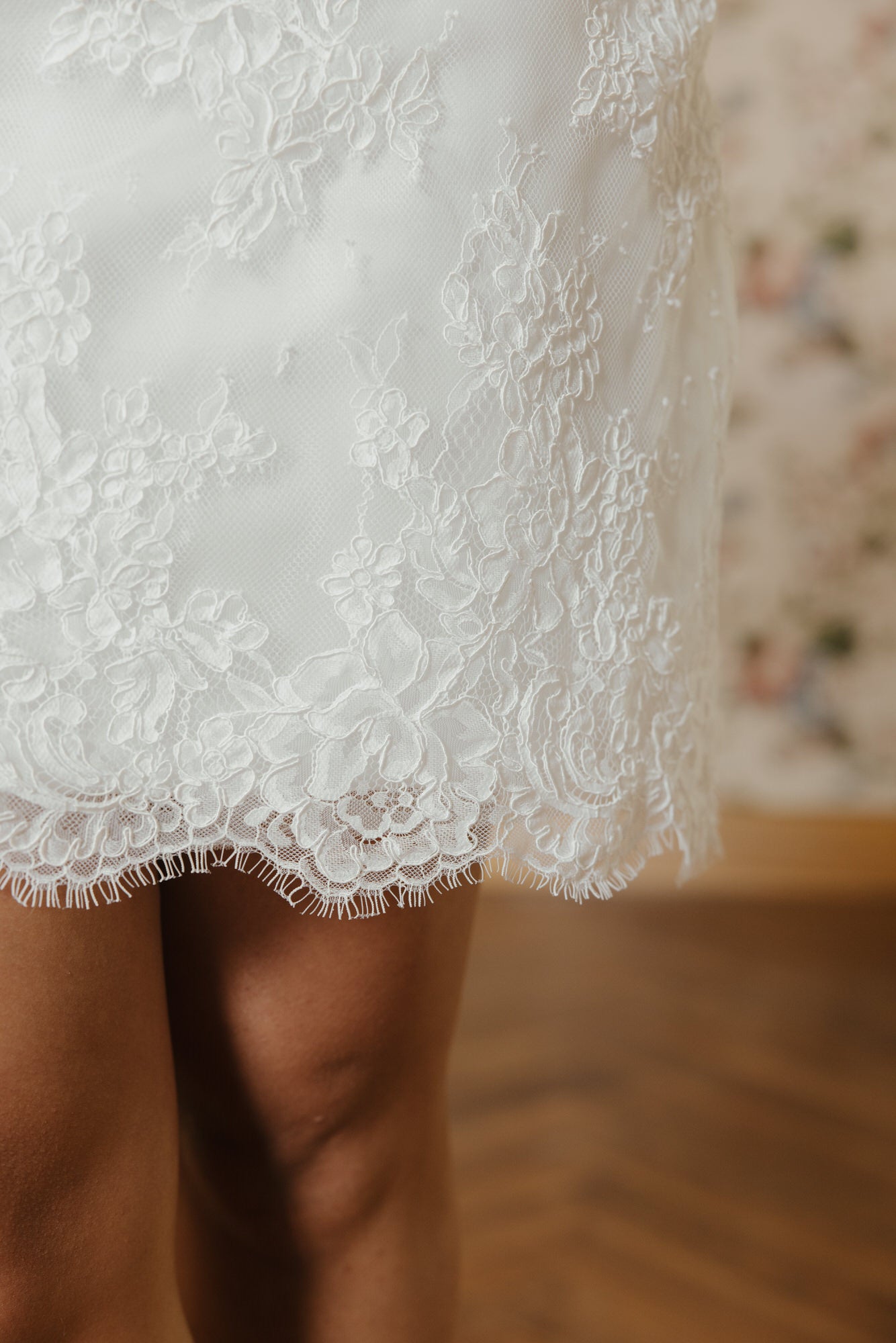 Close-up of a white lace dress with a blurred background