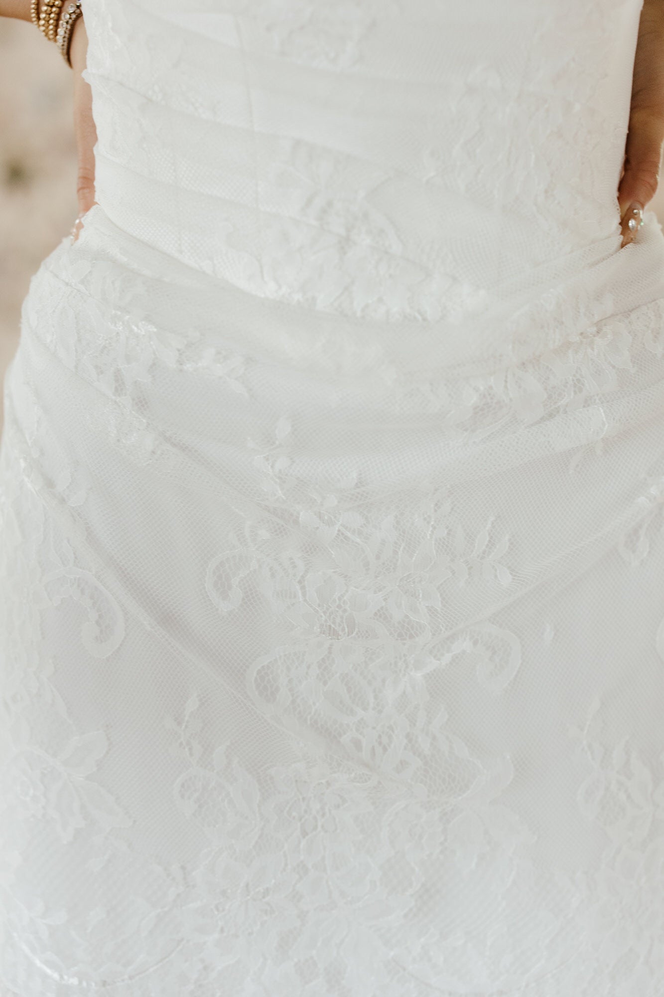 Close-up of a textured white dress with a blurred background