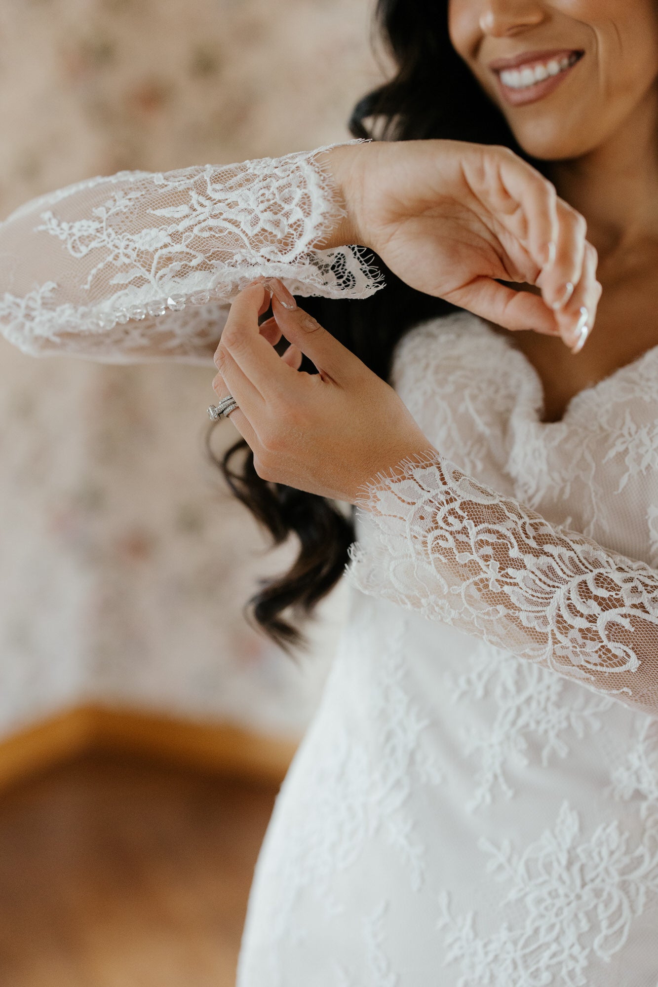 Woman wearing a lace wedding dress with a blurred background